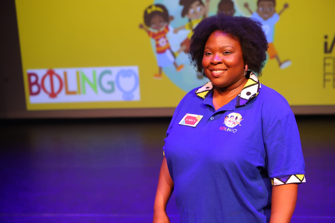 Carla in Bolingo-shirt op het podium van het kinderfilmfestival